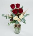 Red and White Roses in a Striped Glass Vase