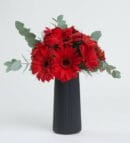 Red Gerbera Flowers in a Black Striped Vase Istanbul